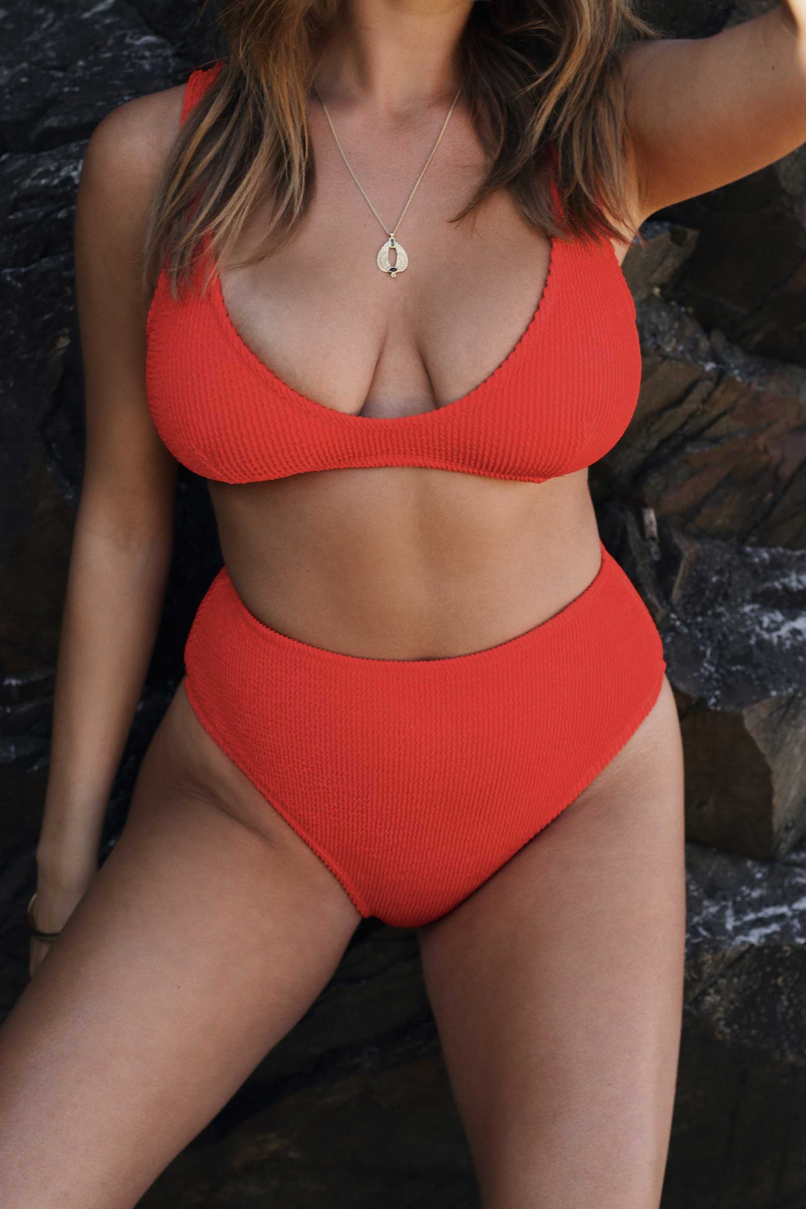 Textured red flattering scoop neck bikini top with thick shoulder straps and adjustable tie-back. 