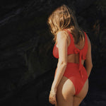 Textured red flattering scoop neck bikini top with thick shoulder straps and adjustable tie-back. 