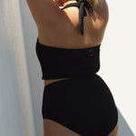 Textured black halter bikini top showing tie-neck and open back, designed for comfort and coverage.