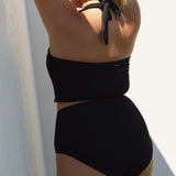 Black halter bikini top with built-in support, flattering plunge neckline and adjustable tie-neck.