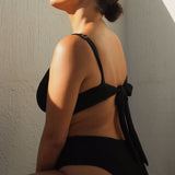 A supportive black textured underwire bikini top with flattering plunge neckline, power mesh lining and adjustable back tie for custom fit. 