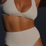 High-waisted white bikini bottom with a cheeky cut, crafted from premium textured 5D fabric. Features power mesh lining for contouring, sculpting and superior support.