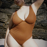 Textured caramel brown full coverage one piece swimsuit with a flattering plunge neckline, underwire bust support and adjustable shoulder straps.