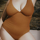 Textured caramel brown full coverage one piece swimsuit with a flattering plunge neckline, underwire bust support and adjustable shoulder straps.