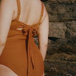 Textured caramel brown full coverage one piece swimsuit with a flattering plunge neckline, underwire bust support and adjustable shoulder straps.