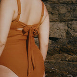 Textured caramel brown full coverage one piece swimsuit with a flattering plunge neckline, underwire bust support and adjustable shoulder straps.