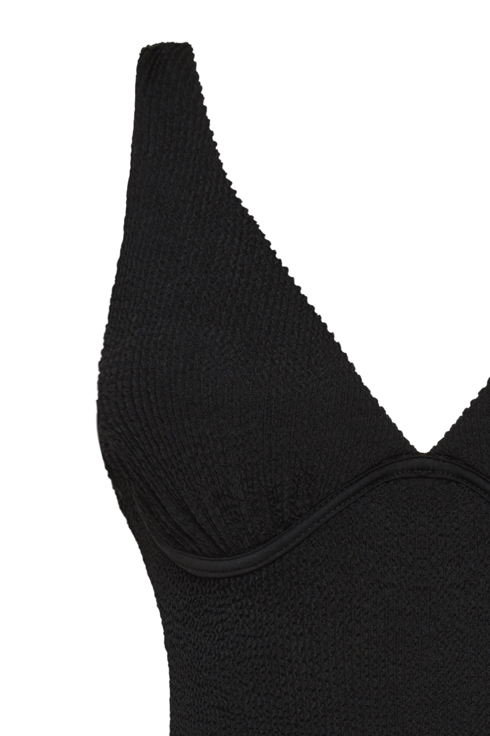 Textured black full coverage one piece swimsuit with a flattering plunge neckline, underwire bust support and adjustable shoulder straps.