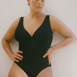 Textured black full coverage one piece swimsuit with a flattering plunge neckline, underwire bust support and adjustable shoulder straps.