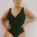 Textured black full coverage one piece swimsuit with a flattering plunge neckline, underwire bust support and adjustable shoulder straps.