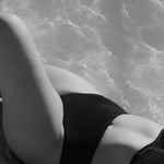 High-waisted black bikini bottom with a cheeky cut back, crafted from premium textured 5D fabric.