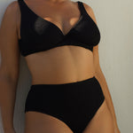 A supportive black textured underwire bikini top with flattering plunge neckline, power mesh lining and adjustable back tie for custom fit. 