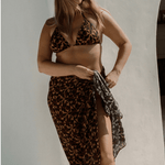 Bree McCann wearing bokumaia noir hibiscus floral sarong styled with matching bikini high waist beach wrap cover up