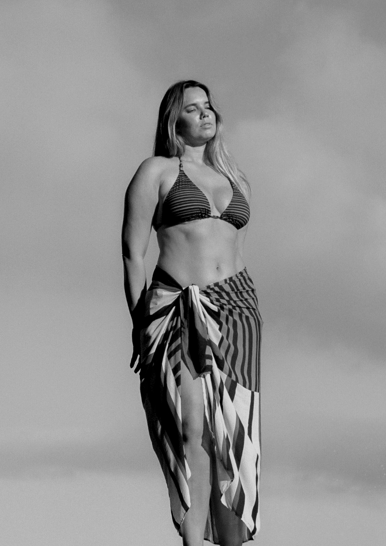 bokumaia mocha stripe large sarong tied at waist paired with striped bikini beach cover up