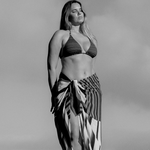 bokumaia mocha stripe large sarong tied at waist paired with striped bikini beach cover up