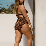 High-waisted full coverage Fior Bikini Bottom in Noir Hibiscus by Bokumaia, shown on body outdoors