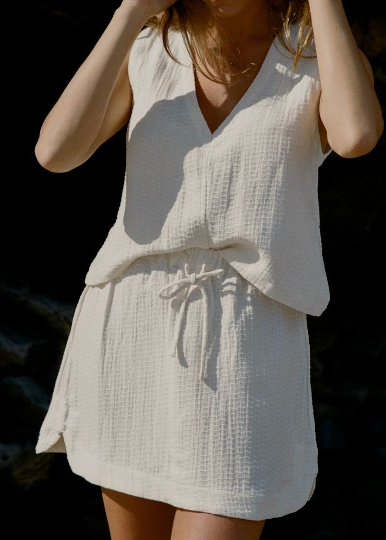 Sahara Mini Skirt Ecru close up paired with Echo Tank for beach to bar wear