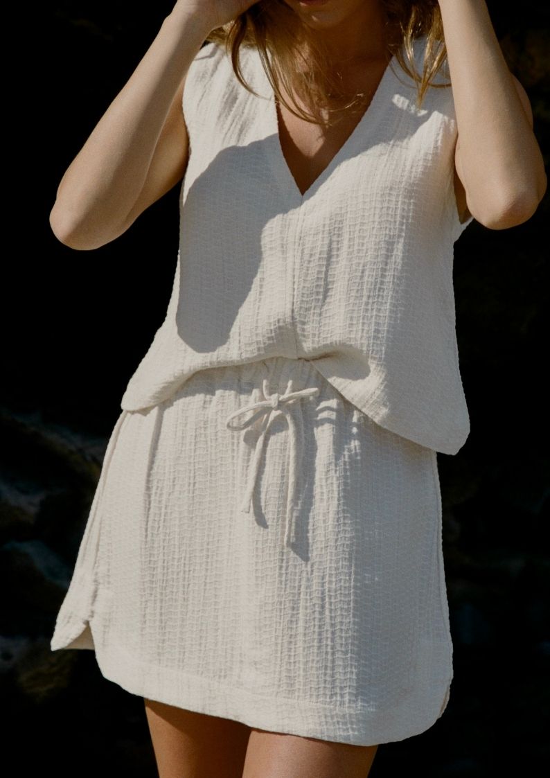 Sahara Mini Skirt Ecru close up paired with Echo Tank for beach to bar wear