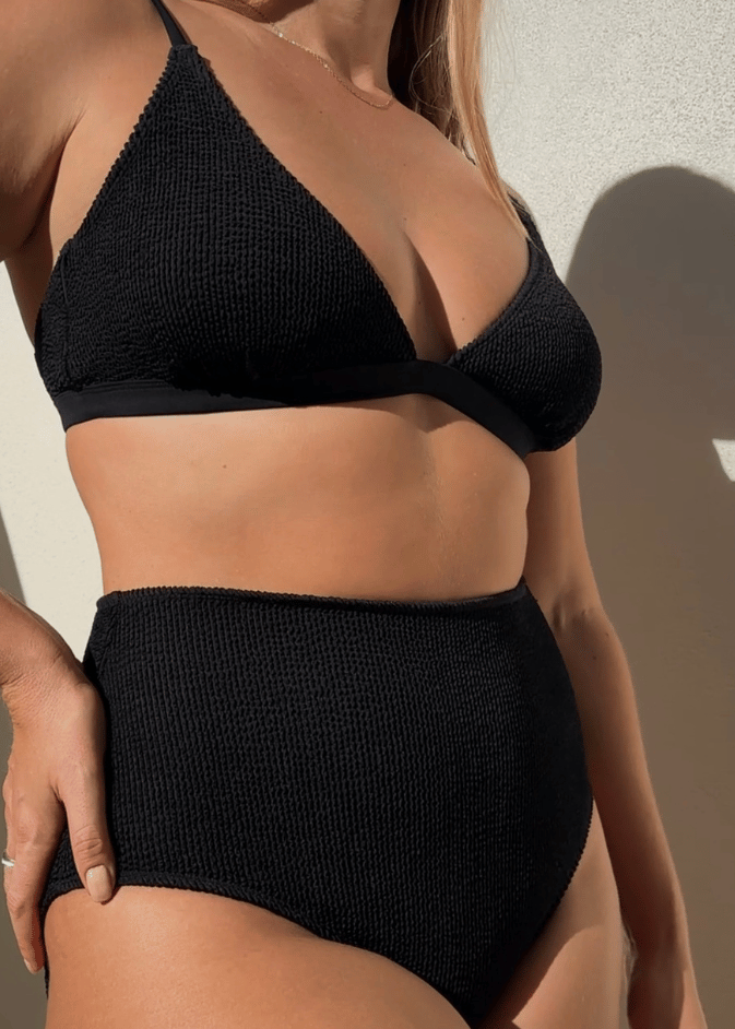 Woman wearing Bokumaia black textured triangle bikini top with supportive plunge fit and seamless shaping.